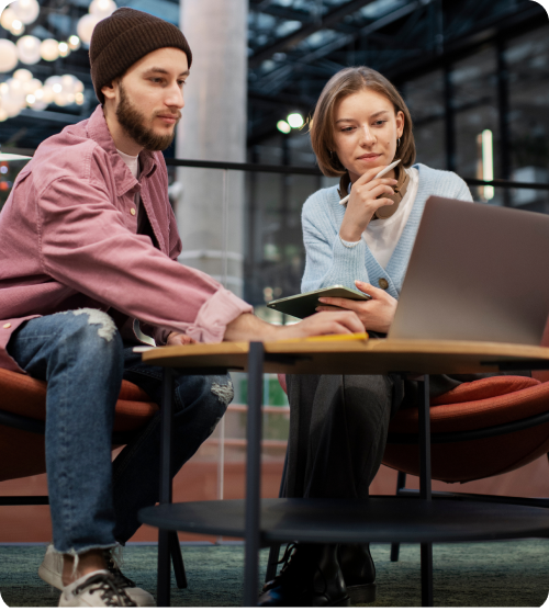 Two professionals collaborating over a laptop