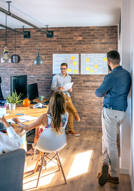 Team collaborating in modern brick-walled office